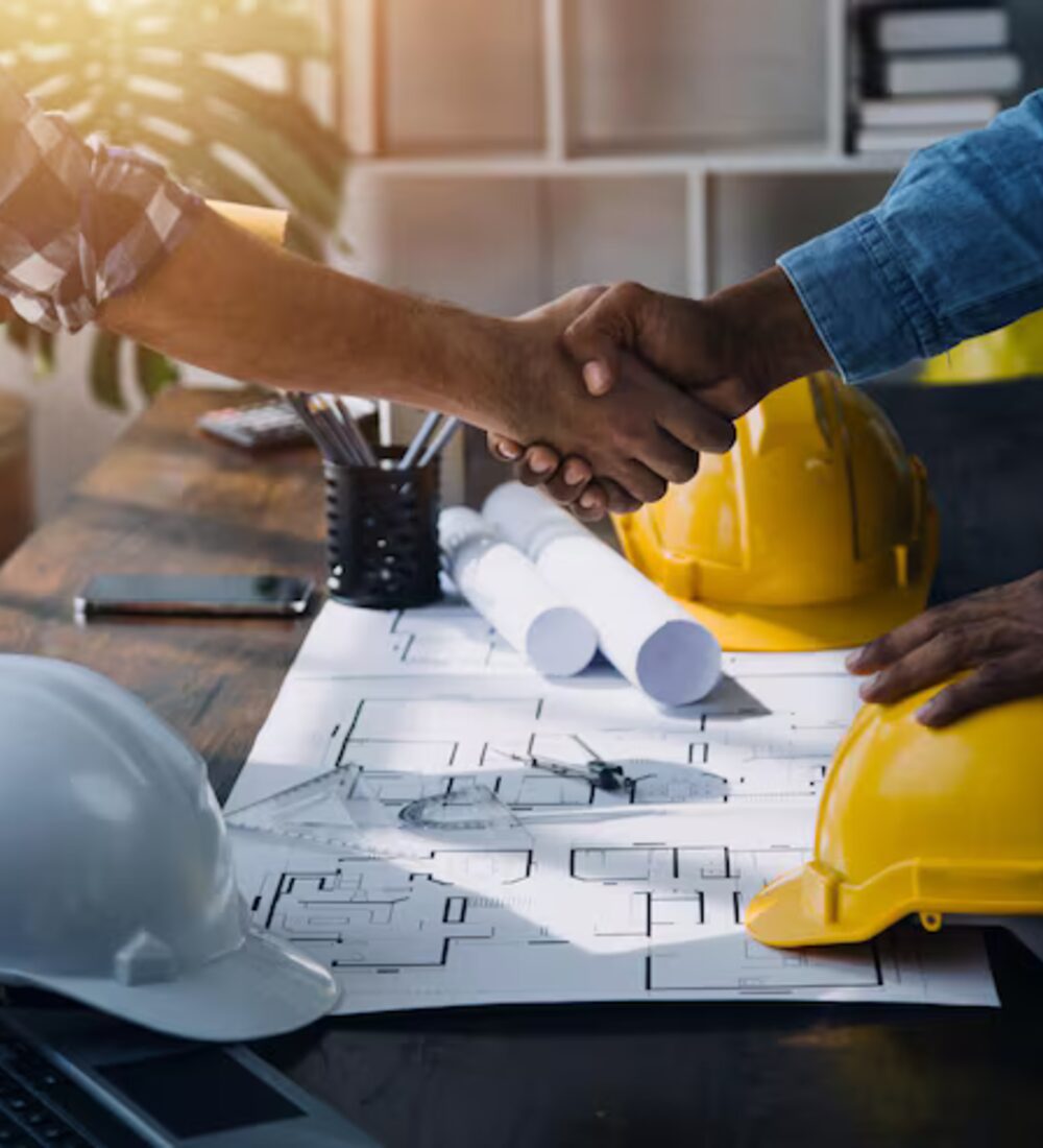 Engineers reviewing a project blueprint on site